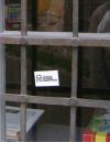 Signed vandalism: stickers with the logo of the mining labour union on the windows of the Unitarian parish house, near the vandalized construction site description